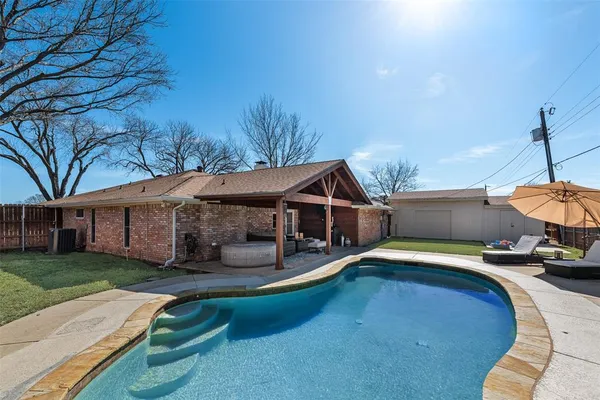 a view of a house with pool and sitting area