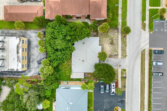 aerial view of a house with a yard and potted plants