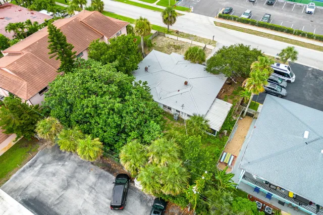 an aerial view of a house with a yard pool outdoor seating and yard