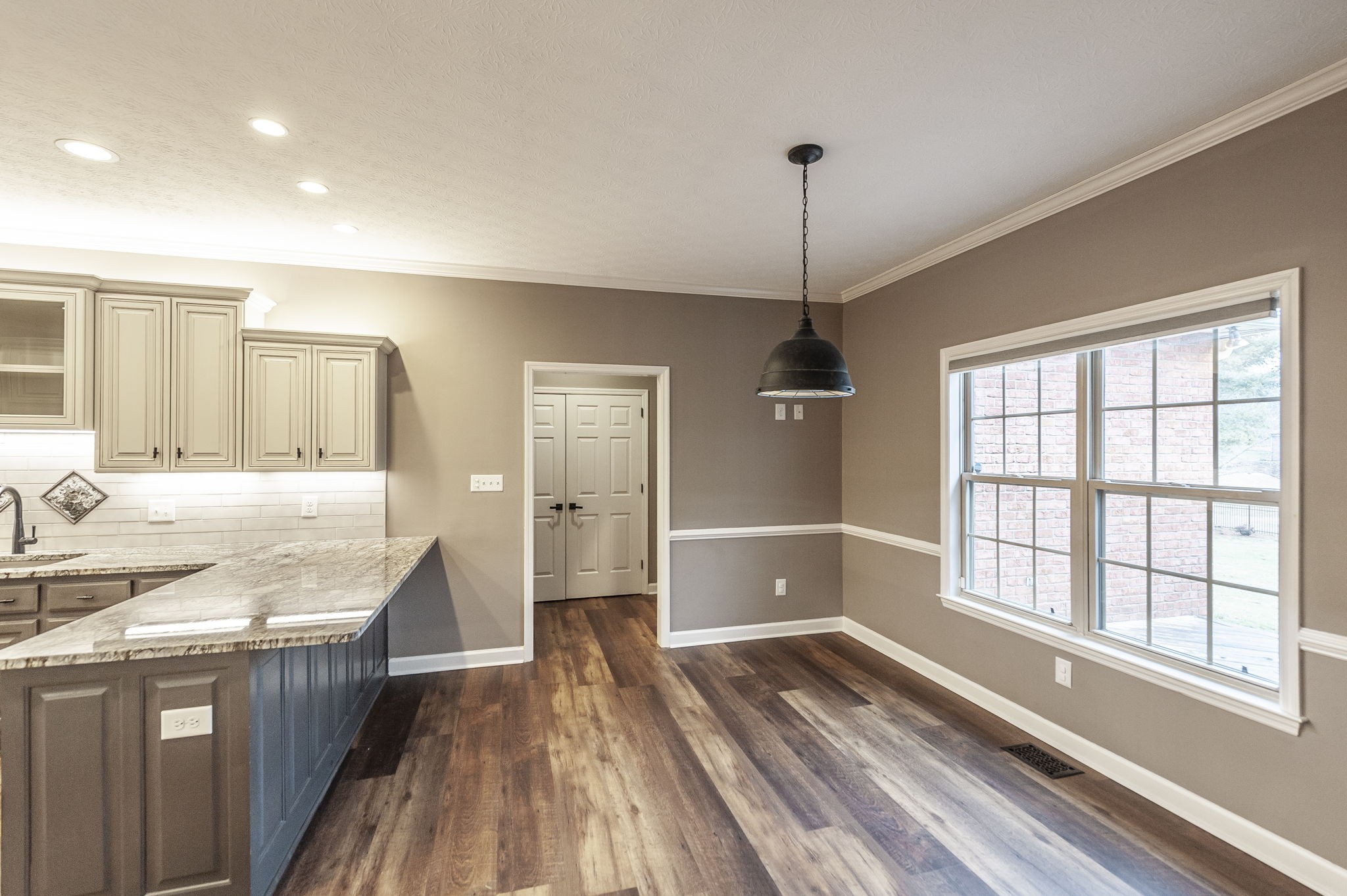1133 Inneswood Drive Gallatin, TN 37066 - Photo 12 of 57 a kitchen with stainless steel appliances granite countertop a refrigerator a sink dishwasher a stove and white countertops with wooden floor