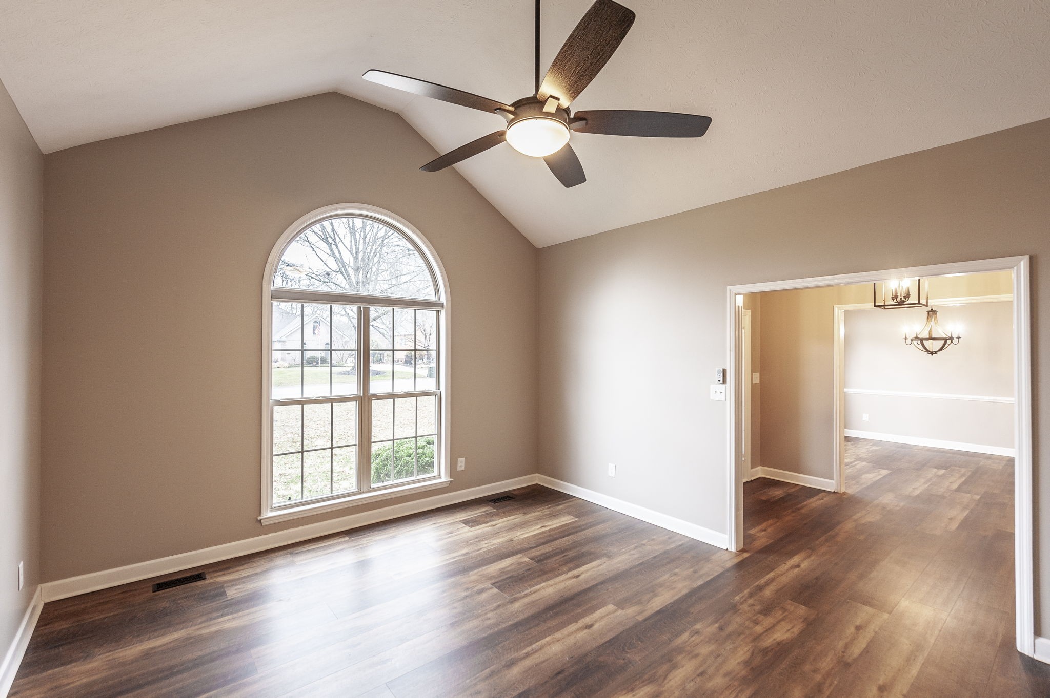 1133 Inneswood Drive Gallatin, TN 37066 - Photo 15 of 57 an empty room with wooden floor chandelier fan and windows