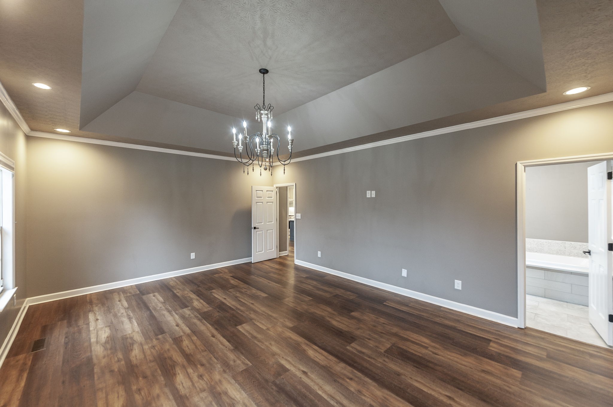 1133 Inneswood Drive Gallatin, TN 37066 - Photo 25 of 57 a view of an empty room with wooden floor and chandelier