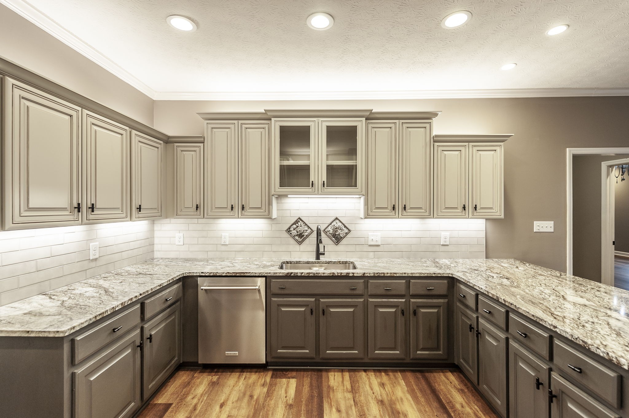 1133 Inneswood Drive Gallatin, TN 37066 - Photo 7 of 57 a kitchen with granite countertop stainless steel appliances a sink stove and cabinets