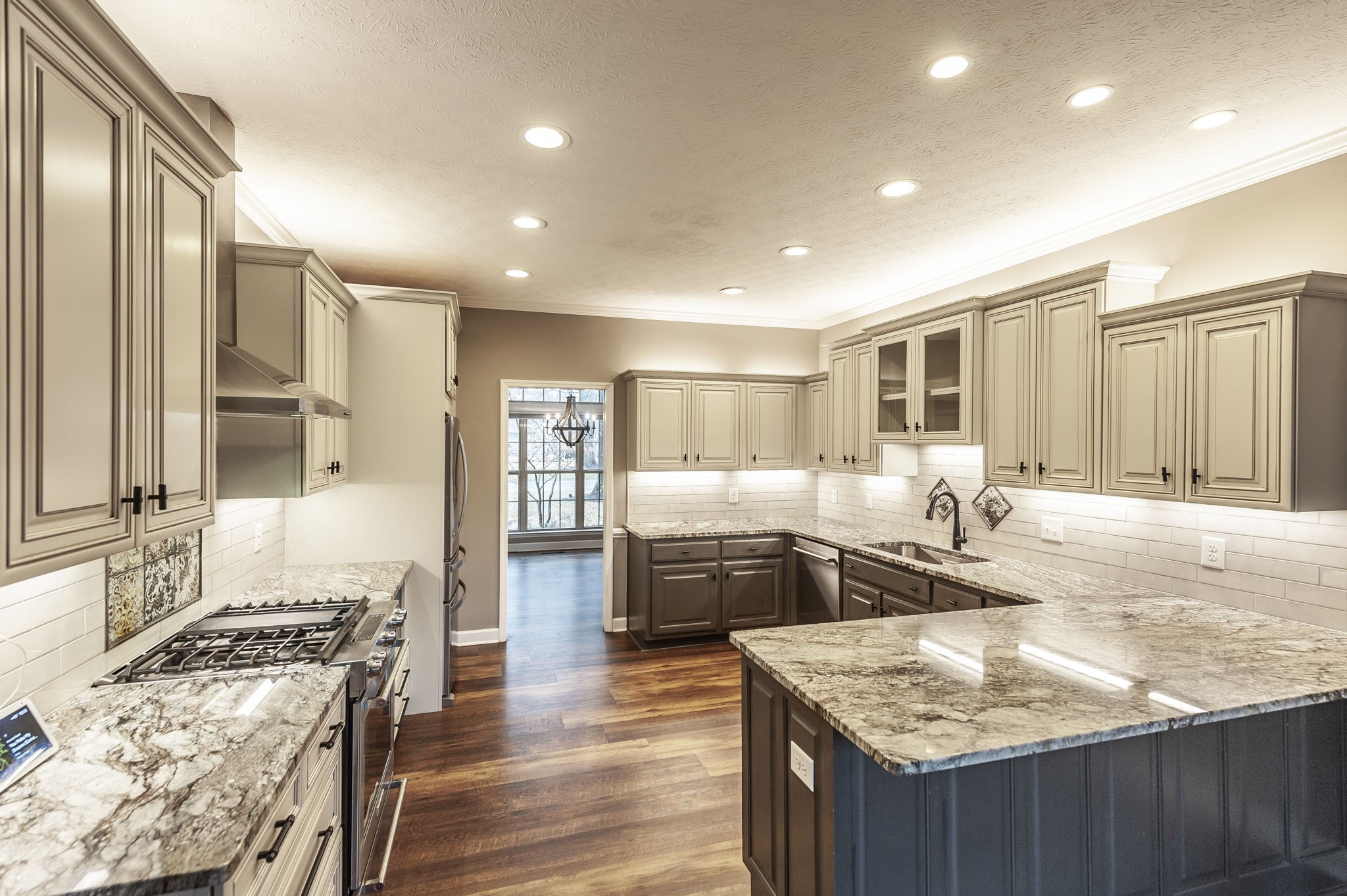 1133 Inneswood Drive Gallatin, TN 37066 - Photo 8 of 57 a kitchen with stainless steel appliances granite countertop a stove top oven a sink dishwasher and wooden cabinets with wooden floor