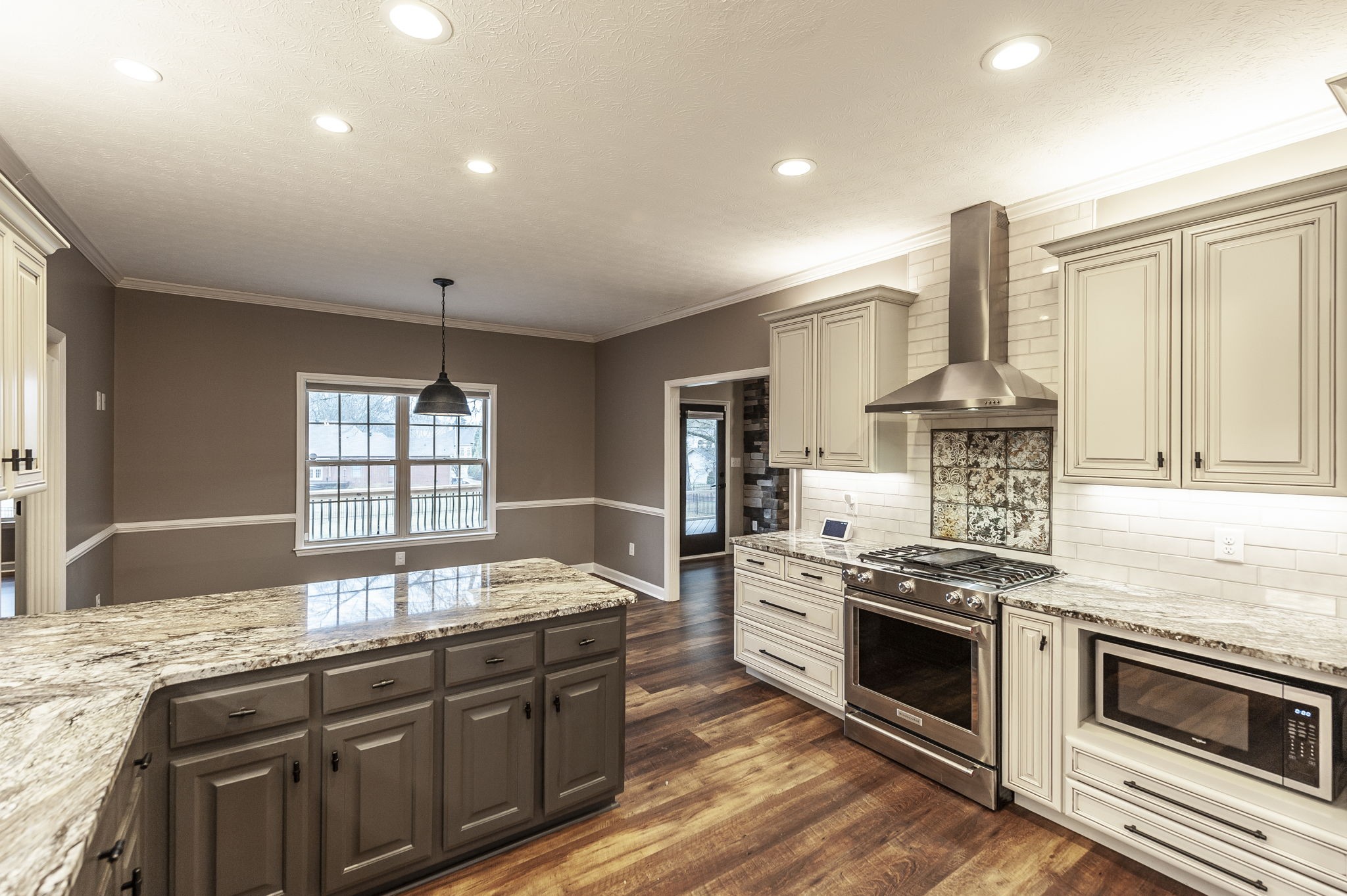 1133 Inneswood Drive Gallatin, TN 37066 - Photo 9 of 57 a kitchen with stainless steel appliances granite countertop a stove a sink and a microwave