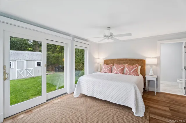 a bedroom with a large bed and a view of balcony