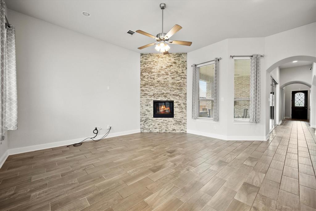 4861 Verbena Way Prosper, TX 75078 - Photo 12 of 38 a view of an empty room with a fireplace and a window