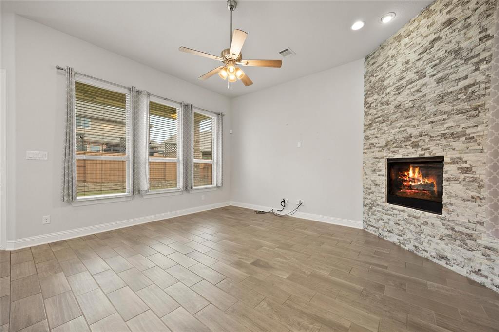 4861 Verbena Way Prosper, TX 75078 - Photo 14 of 38 an empty room with windows and fireplace