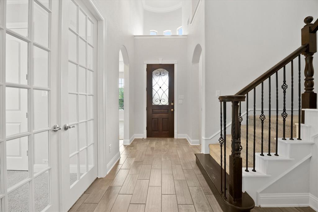 4861 Verbena Way Prosper, TX 75078 - Photo 3 of 38 a view of a hallway with wooden floor and staircase