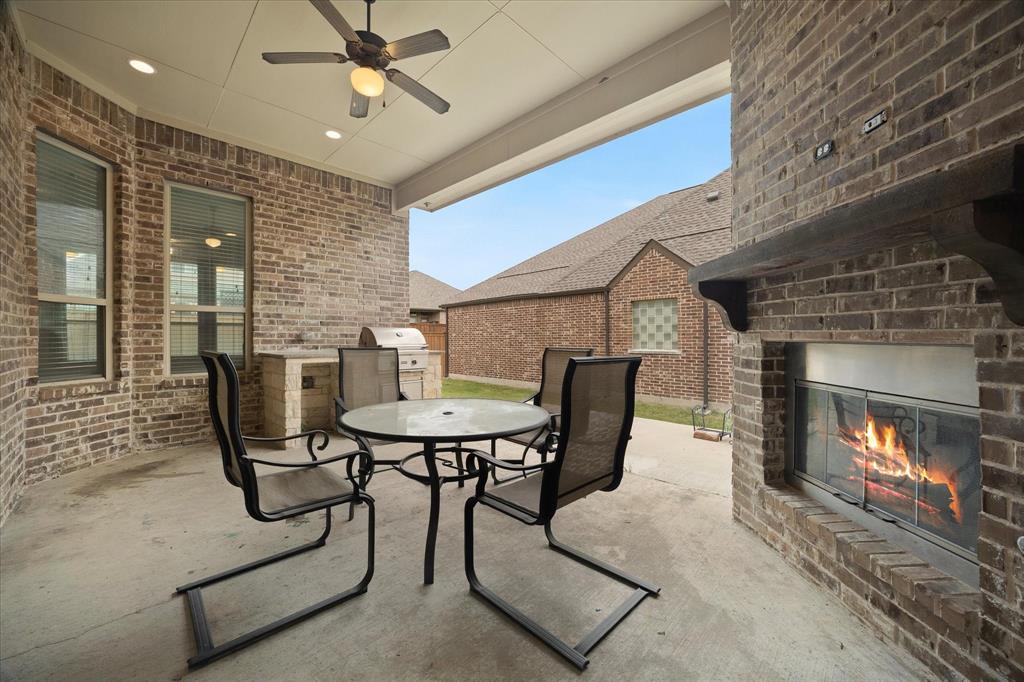 4861 Verbena Way Prosper, TX 75078 - Photo 36 of 38 a view of a livingroom with furniture and a fireplace