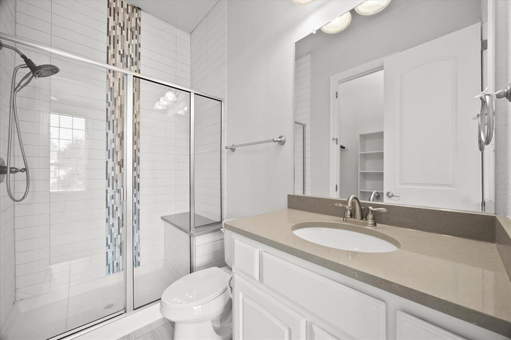 4861 Verbena Way Prosper, TX 75078 - Photo 7 of 38 a bathroom with a granite countertop sink toilet and shower