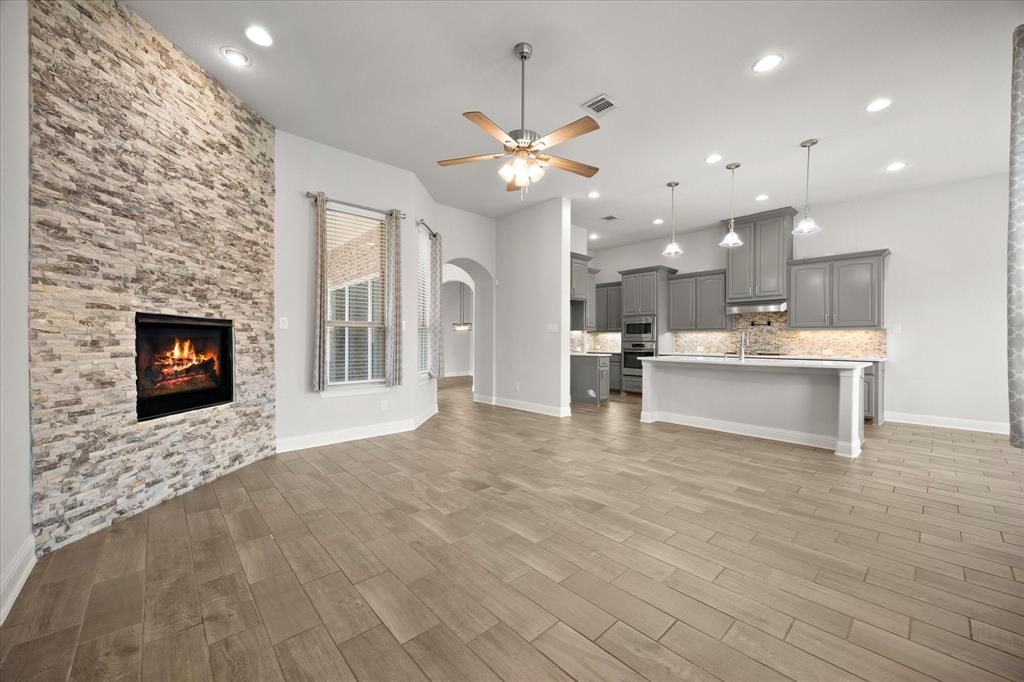 4861 Verbena Way Prosper, TX 75078 - Photo 10 of 38 a view of a kitchen with a sink and a fireplace