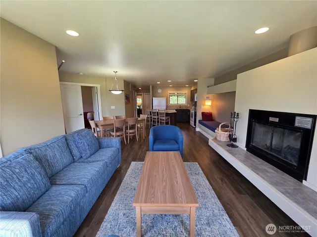 a living room with furniture fireplace and a table