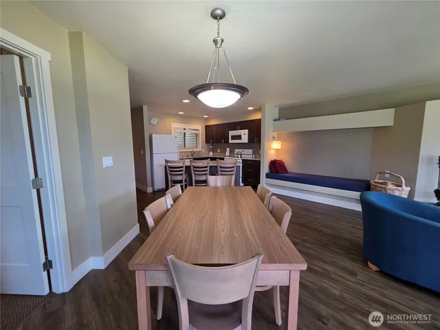 a dining room with furniture and wooden floor