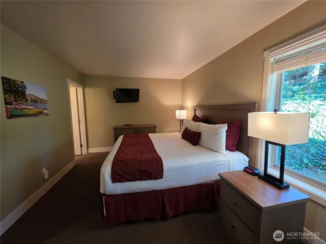 a bedroom with bed and a window