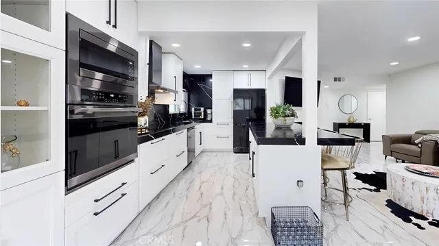 a kitchen with stainless steel appliances and sink