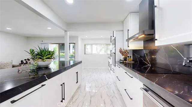 a kitchen with granite countertop a sink and a stove top oven