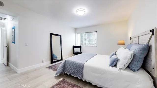 a bedroom with a bed and a chair