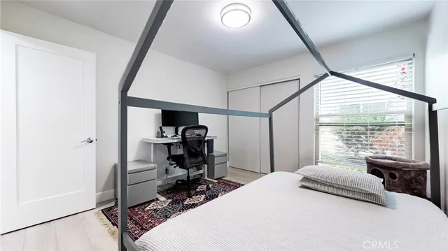 a bedroom with a bed and flat screen tv