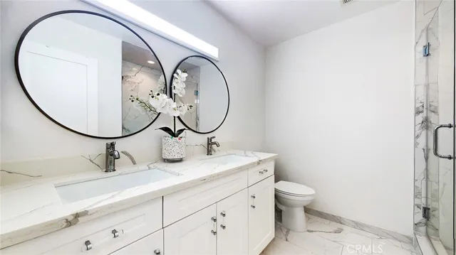 a bathroom with a toilet a sink and a mirror