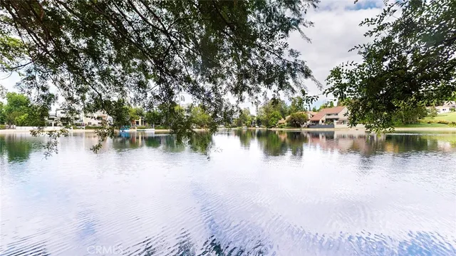 a view of a golf course with an outdoor space and seating
