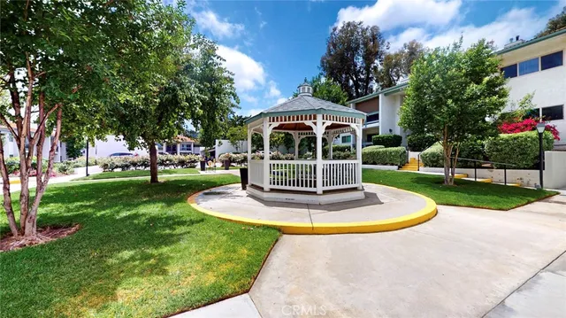 a view of a patio with a table and chairs and potted plants