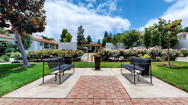 a view of a back yard with flower plants