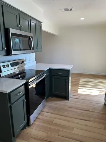 a kitchen with a stove and a microwave