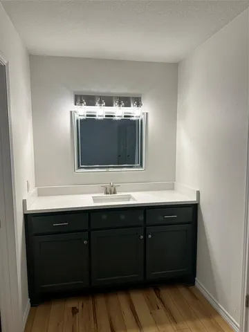 a bathroom with a double vanity sink and mirror