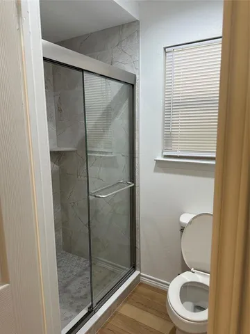 a bathroom with a granite countertop toilet and a sink