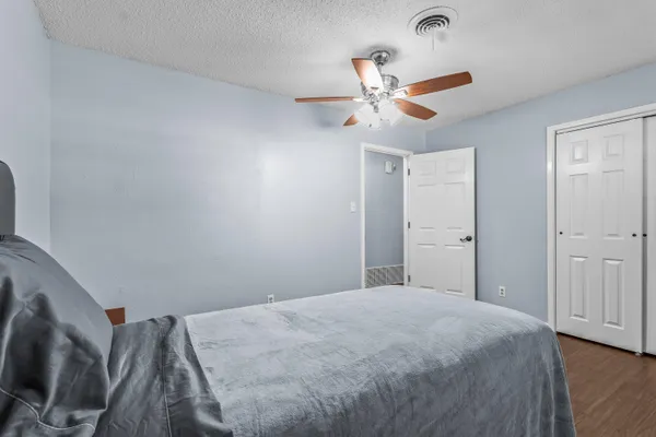 a bedroom with a bed and a chandelier
