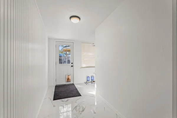 a picture of a rug and a window in a room