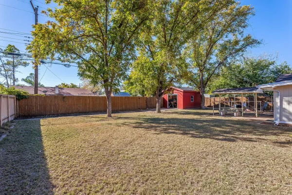 a view of a yard with large trees