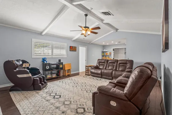 a living room with furniture a couch and dresser