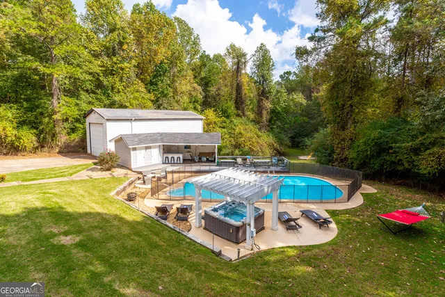 a view of a swimming pool with a yard
