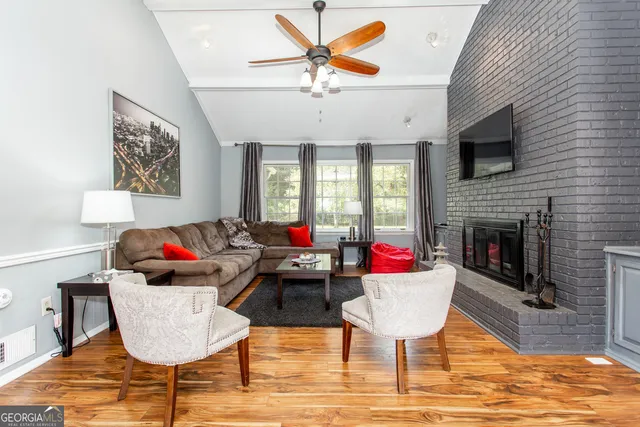 a living room with furniture and a fireplace