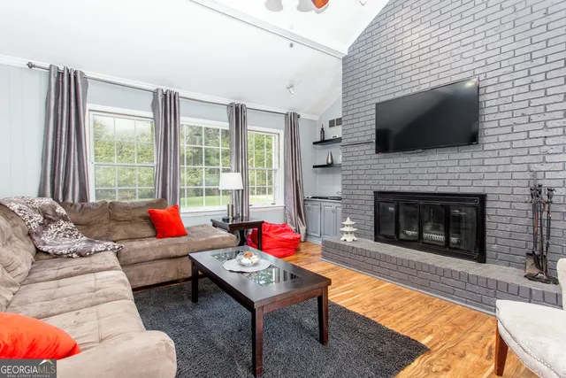 a living room with furniture fireplace and flat screen tv