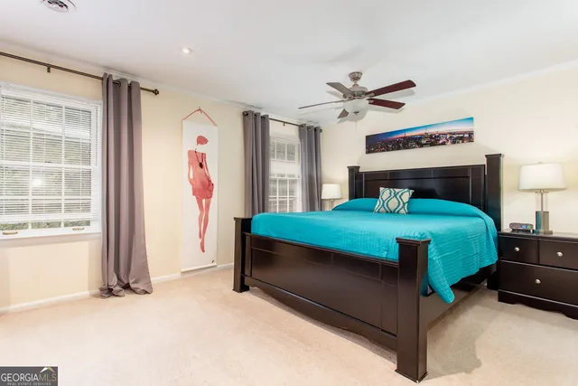 a bedroom with a bed and a large window