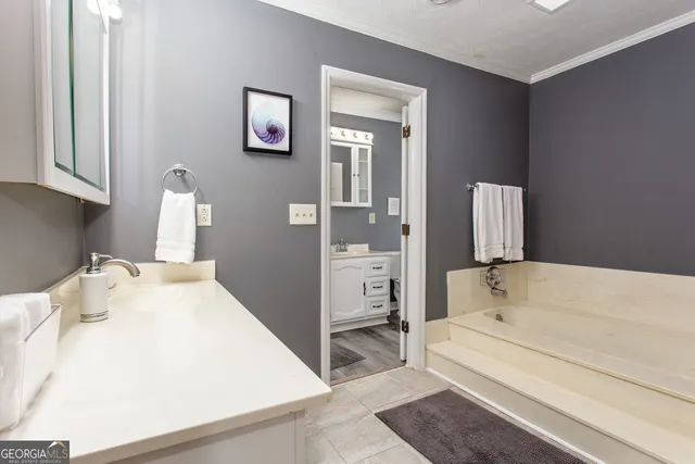 a en suite bathroom with a tub and sink