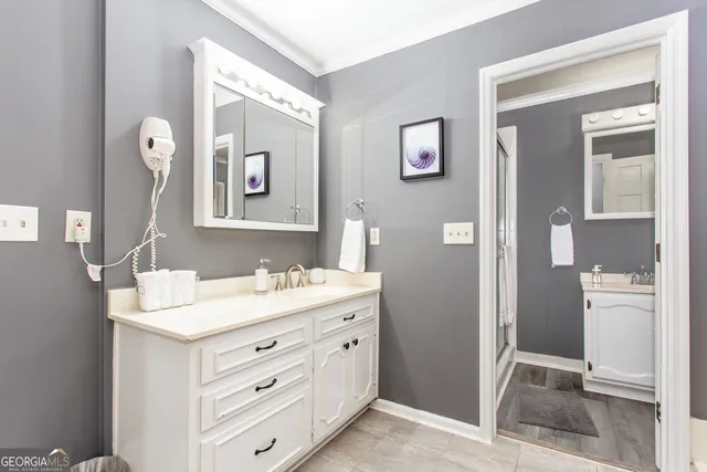 a bathroom with a double vanity sink a mirror and a