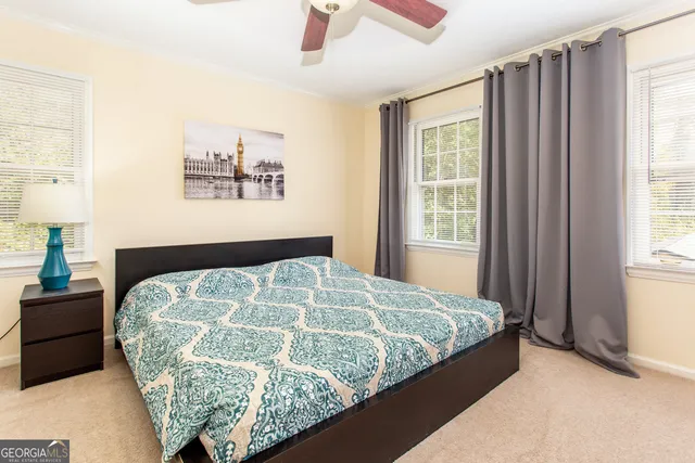 a bed sitting in a bedroom next to a window