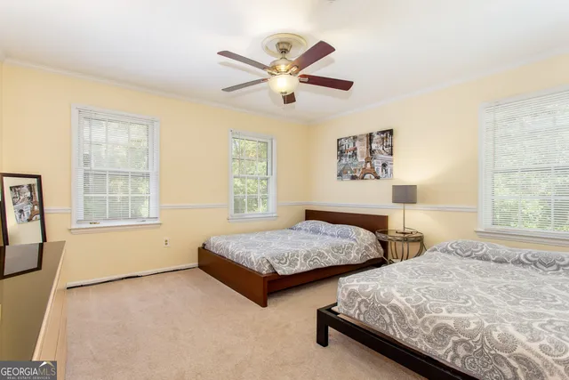 a bedroom with two large bed and two windows
