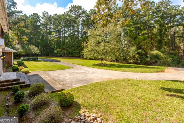 a view of a swimming pool with an outdoor space and seating area