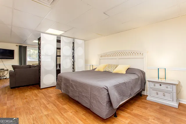 a bedroom with a bed and a couch