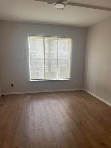 a bathroom with a sink a toilet a window and vanity