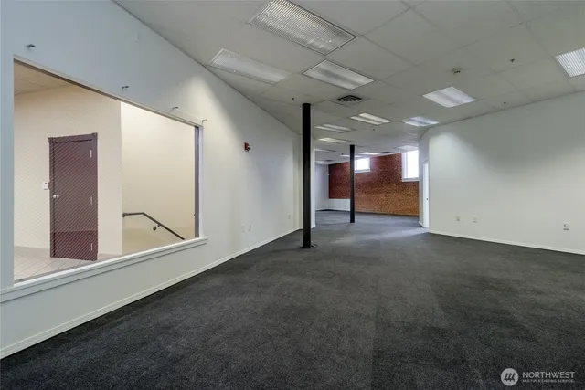 an empty room with windows and entrance