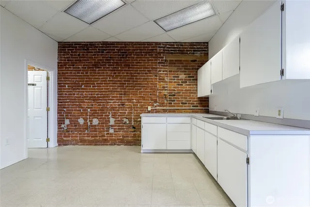 a view of a livingroom with an empty space and a window