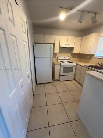 a kitchen with a stove a refrigerator a sink and dishwasher