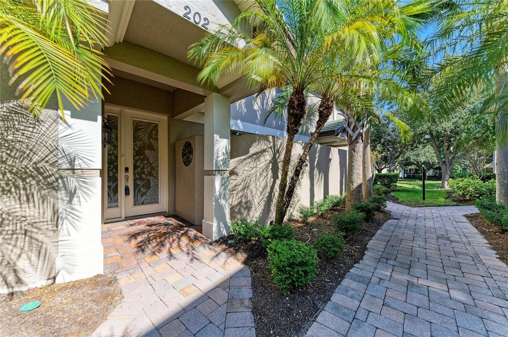 6560 Moorings Point Circle, Unit 202 Lakewood Ranch, FL 34202 - Photo 1 of 1 a front view of a house with a yard