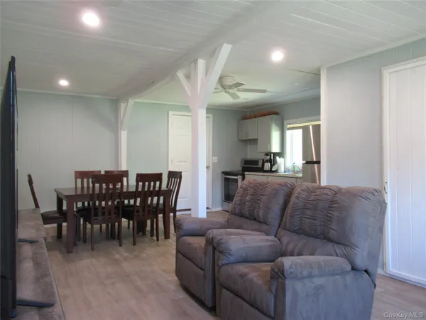 a living room with furniture a dining table and a couch
